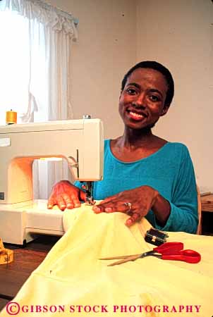 Stock Photo #4411: keywords - african american black chore cloth clothes clothing craft create ethnic fabric female fix hobby home house household learn machine make minority mother released repair sew sewer sewing skill vert wife woman work