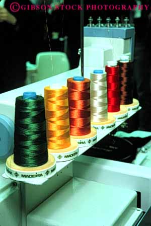 Stock Photo #4413: keywords -  color colorful commercial cone create fabric feeder machine manufacture manufactured manufacturing rotate round row sew sewing spools string supply thread vert