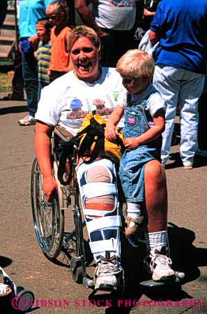 Stock Photo #4435: keywords -  broken cast challenge challenged child disability disabled disadvantage disadvantaged handicap handicapped impair impaired injury leg mother need needs special vert wheelchair woman