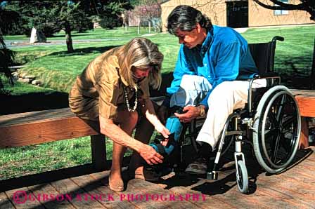 Stock Photo #4446: keywords -  assist care challenge challenged couple disability disabled disadvantage disadvantaged giving handicap handicapped help horz husband impair impaired injury need needs released share special together wheelchair wife
