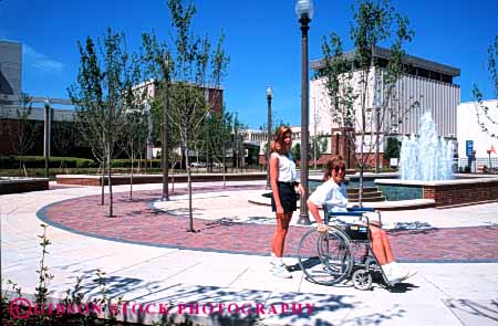 Stock Photo #4461: keywords -  assist challenge challenged disability disabled disadvantage disadvantaged handicap handicapped help helper horz impair impaired in need needs park special summer wheelchair woman women