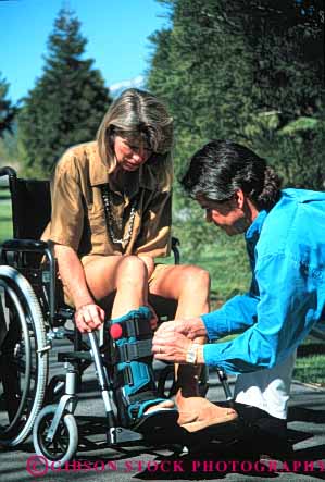 Stock Photo #4463: keywords -  assist challenge challenged disability disabled disadvantage disadvantaged handicap handicapped help husband impair impaired injury need needs released share special team together vert wheelchair wife