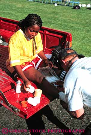 Stock Photo #4473: keywords -  african aid american ankle black body brace ethnic first girl hurt injury medical medicine minority nurse race released soccer sports support tapes team trainer treat treatment vert woman