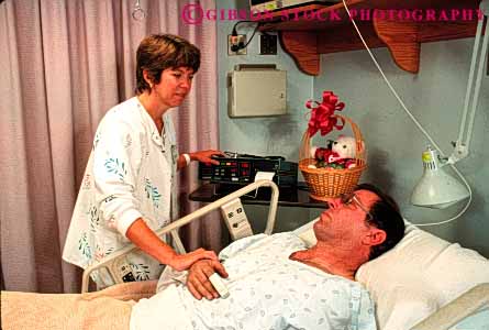 Stock Photo #4486: keywords - assist assistance assisting attend attendant attendants attention bed care client clients examine give giver giving health healthcare help hold horz hospital intensive man medical medicine nurse nursing patient recovery released staff steady test treatment