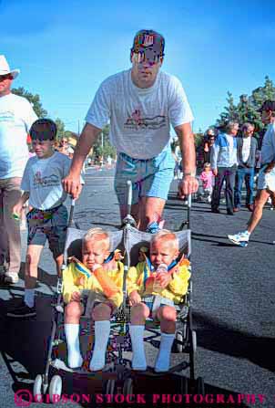 Stock Photo #4510: keywords -  babies bbay boys brother brothers child children father identical look people same sibling stroller twin twins two vert