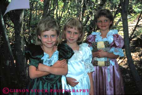 Stock Photo #4512: keywords - adolescence adolescent child children girl girls horz identical look same sibling sister sisters smile three triplet twins