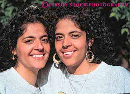 Stock Photo #4516: keywords -  adult child children ethnic face girls happy head hispanic horz identical look minority nationality race same share sibling sisters skin smile teenager teenagers together twin twins two women young