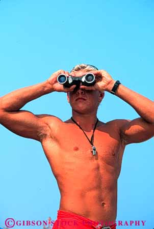 Stock Photo #4564: keywords -  authority bathing beach binoculars career control distance employee fit guard job lifeguard look lookout man observe ocean outdoor outdoors outside physically quick react released rescue respond responder safe safety save season seasonal see skin strong suit summer sun sunny sunshine supervise supervisor swim swimming tan trained vert vision vocation watch work worker working