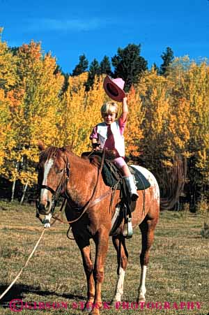 Stock Photo #4589: keywords -  americana child children cowgirl cute five folklore girl horse horseback horseman old outdoor outside pretty ranch released southwest tradition traditional vert west western wrangler year