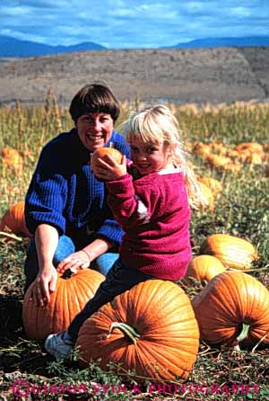 Stock Photo #4630: keywords - autumn child choose country countryside daughter fall family farm find girl grow halloween happy harvest holiday mother orange outdoor outside parent pick produce pumpkins released round season select share single smile squash team together vert vine