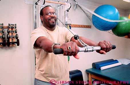 Stock Photo #14847: keywords - african american black body client clients condition conditioning conditions ethnic ethnicity exercise exercising heal healing heals health hold holding holds horz man medical minorities minority patient patients people person physical pulley recover recovers recovery released stationary therapeutic therapy treat treating treatment treatments treats using workout