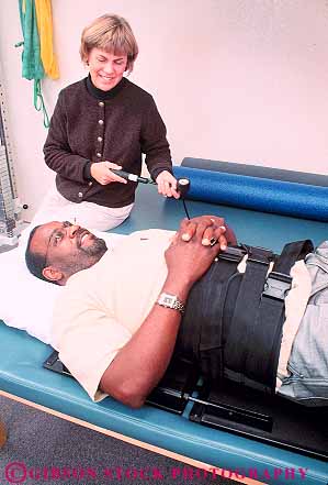 Stock Photo #14853: keywords -  african air american assist assisting back black body care career caregiver cares caring client clients condition conditioning conditions device elder elderly equipment ethnic exercise exercising guidance guide guiding heal healing heals health help helper helpers helping helps hold holding holds into job jobs lumbar man mature medical minorities minority old older patient patients people person physical pressure profession professional pumps recover recovers recovery released seniors therapeutic therapist therapy touch touches touching traction treat treating treatment treatments treats unit vert work worker workers working workout works