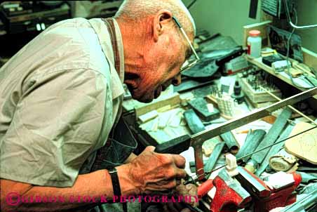 Stock Photo #4769: keywords - alaska american art business careful carve carving commerce craft craftsman create cut eskimo ethnic handmade horz indian jewelry make man minority native nome original product released saw shop tool tradition traditional tribe vice walrus