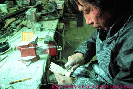 Stock Photo #4773: keywords - alaska american art business carve carving commerce craft craftsman create eskimo ethnic handmade horz indian jewelry make man minority native nome original product released tradition traditional tribe walrus