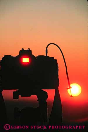 Stock Photo #4802: keywords -  camera cameras dawn dusk equipment orange photo photographer photography picture see silhouette sunrise sunset tool vert view yellow