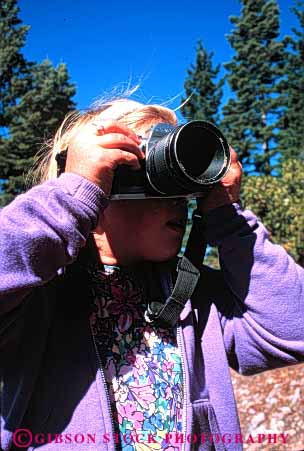 Stock Photo #4805: keywords -  camera cameras child equipment girl lens photo photographer photography picture reflex released see single slr tool use vert view