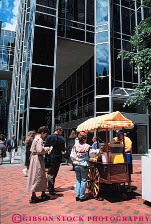 Stock Photo #4869: keywords -  beverage business cart city commerce downtown drink drinks eat economics employee food juice little lunch mobile movable one people person portable retail sell seller selling serve service small snack street vendor vert wagon