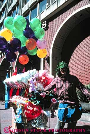 Stock Photo #4877: keywords -  balloon business cart commerce economics little mobile movable one person portable retail sell seller selling serve service small street toy vendor vert wagon