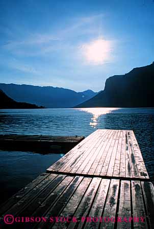 Stock Photo #4908: keywords -  alberta banff boat calm dock glare lake landscape minnewanka reflection scenic shore sun vert water wood