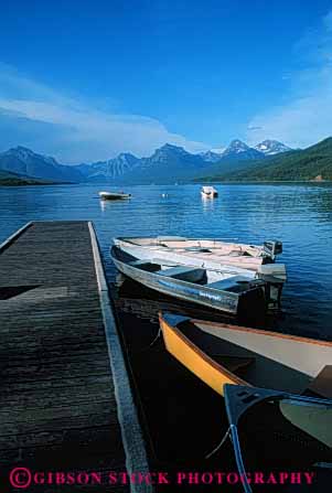 Stock Photo #4909: keywords -  boat boats calm dock glacier lake landscape mcdonald mountain mountains national park quiet scenic shore vert water wood