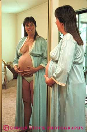 Stock Photo #5043: keywords -  bedroom gown home mirror mother motherhood night pregnant privacy private released self vert woman
