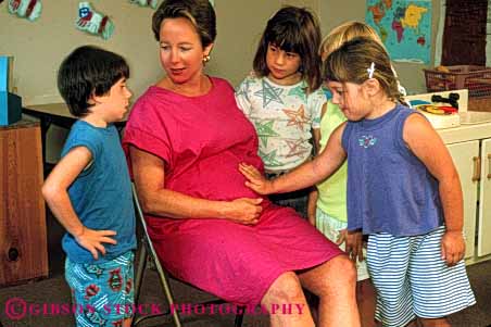 Stock Photo #5046: keywords - boy child children explain girls horz mother motherhood pregnancy pregnant preschool released see students touch wife woman