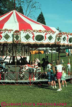 Stock Photo #5114: keywords -  activity amusement around attraction carnival carnivals carousel carousels child children circle circular color colorful event fair fairs families family festival festivals fun grants horz kid kids look merry mobile mother oregon park pass people person play portable recreation ride rides round see stand summer temporary thrill vert