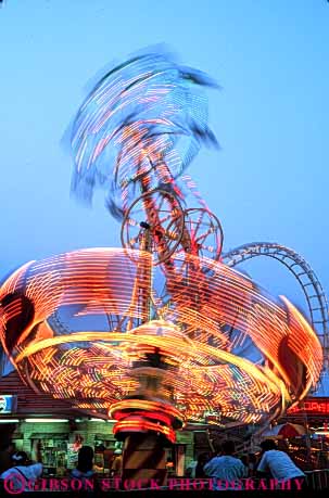 Stock Photo #5174: keywords -  amusement city dusk dynamic fair festival fun light lighting motion move movement moving ocean park play rides spin summer sunset thrill twirl vert