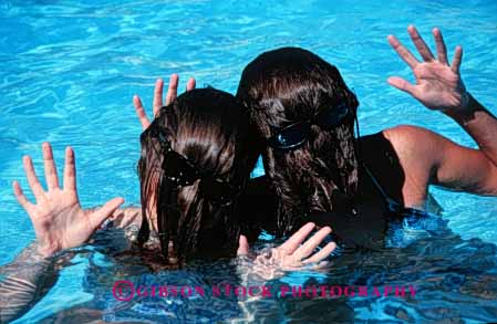 Stock Photo #5222: keywords -  backward backwards cute different face faces fun funny girls hair hairy hand hands head horz humor humorous outdoor peculiar pool released strange summer sunglasses swim swimming water wave wet