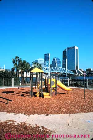 Stock Photo #5229: keywords -  buildings childhood chips city clean climb climbing color colorful downtown florida geometric geometry ground jacksonville metal new plastic play playground safe shape shapes skyline slide toy vert wood