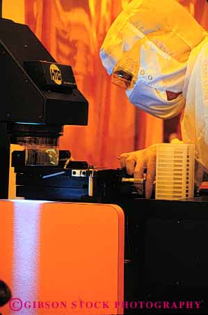 Stock Photo #5255: keywords - career cleanroom close closely component computer detail electric electrical electricity employee enlarge equipment exact examine high industry job light lighted look magnifier magnify manufacture manufacturing occupation orange person precise precision research room science see tech technical technician technicians technology test tool vert view vision vocation work worker working