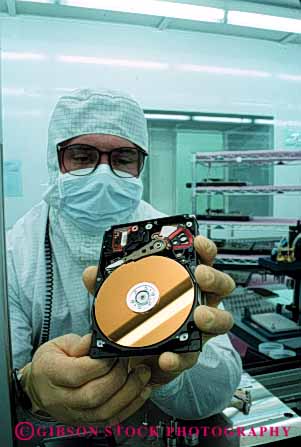 Stock Photo #5275: keywords - assemble assembling assembly career clean cleanroom computer disk drive electric electrical electricity electronic electronics employee equipment exact hard high industry job manufacture manufacturing memory occupation precise precision quantum research room science tech technical technician technology vert vocation work worker
