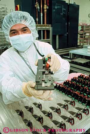Stock Photo #5277: keywords - assemble assembling assembly career clean cleanroom computer disk drive electric electrical electricity electronic electronics employee equipment exact hard high industry job manufacture manufacturing memory occupation precise precision quantum research room science tech technical technician technology vert vocation work worker