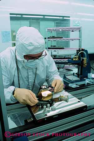 Stock Photo #5278: keywords - assemble assembling assembly career clean cleanroom computer disk drive electric electrical electricity electronic electronics employee equipment exact hard high industry job manufacture manufacturing memory occupation precise precision quantum research room science tech technical technician technology vert vocation work worker