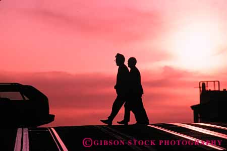 Stock Photo #5333: keywords -  across city cross horz men move pavement pedestrians people road silhouette step street walk walker walking