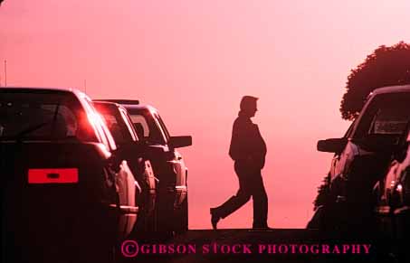 Stock Photo #5334: keywords -  across between cars city cross horz man move pavement pedestrian people road silhouette step street traffic walk walker walking