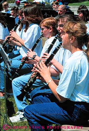 Stock Photo #5403: keywords -  band chair clarinet clarinets cute female girls group harmonize harmony high instrument music noise outdoor outdoors outside perform performance performers play pretty reed school share shirt sit sitting sound team teen teenage teenager teenagers teens together vert white wind woman women young