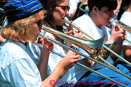 Stock Photo #5404: keywords -  band brass chair group harmonize harmony high horn horz instrument man music musical noise outdoor outdoors outside perform performance performers play school share shirt sit sitting sound team teen teenage teenager teenagers teens together trombones white wind woman women young