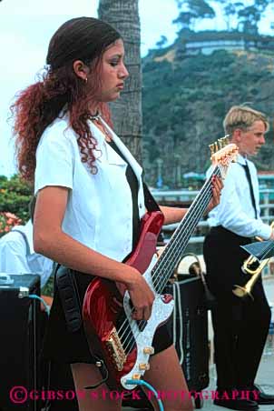 Stock Photo #5405: keywords - adult band class ethnic field group guitar high hispanic interaction minority music outdoor outdoors outside perform performance performers play recreation school social sound student students summer teen teenager teenagers trip unison unity vert woman women young