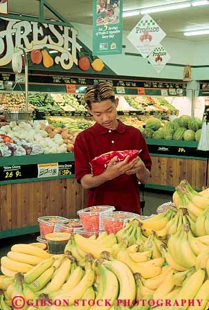Stock Photo #13368: keywords - adolescent adolescents asian boy boys buy buyer buyers buying children customer customers ethnicity grocery in indoor indoors inside interior label male minorities minority package people race races read reading reads released shop shopper shoppers shopping store stores teen teenage teenagers vert young youth