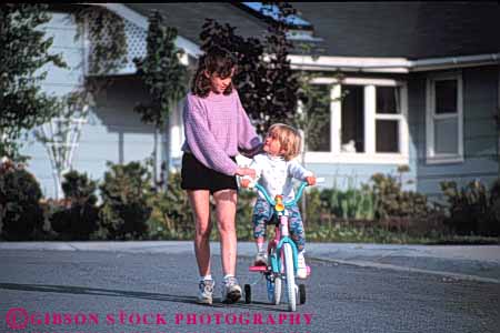 Stock Photo #5430: keywords - adolescence adolescent adolescents adult assist assistance balance bike children class friend friends girls group guide help high horz interaction junior learn middle neighborhood older outdoor outdoors outside practice recreation released ride safe safety school sister social stabilize stable street student students summer tech teen teenager teenagers teens woman women young younger