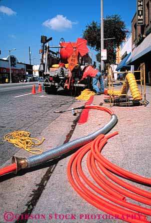 Stock Photo #5450: keywords -  angeles communication communications conduit downtown fiber install job labor laborer los occupation optic optics orange pipe plastic public road street technician technicians technology telecommunications tube under utilities utility vert work worker working